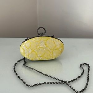 Yellow appliqué clutch with removable chain detail strap